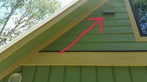 Picture of HRV outdoor-air intake with red arrow for homeowner manual.