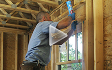 Picture of window being air-sealed from the interior.