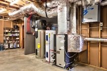 Picture of Bosch, geothermal, ground source heat pump equipment inside mechanical room.